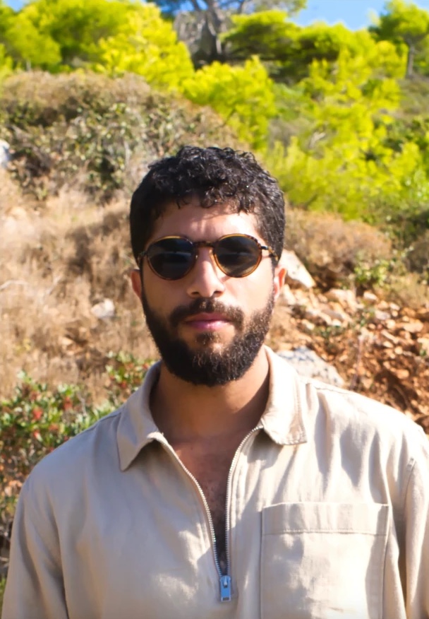 Tamir Barzilai, host of Nectar of Time, outdoors on a sunlit hillside